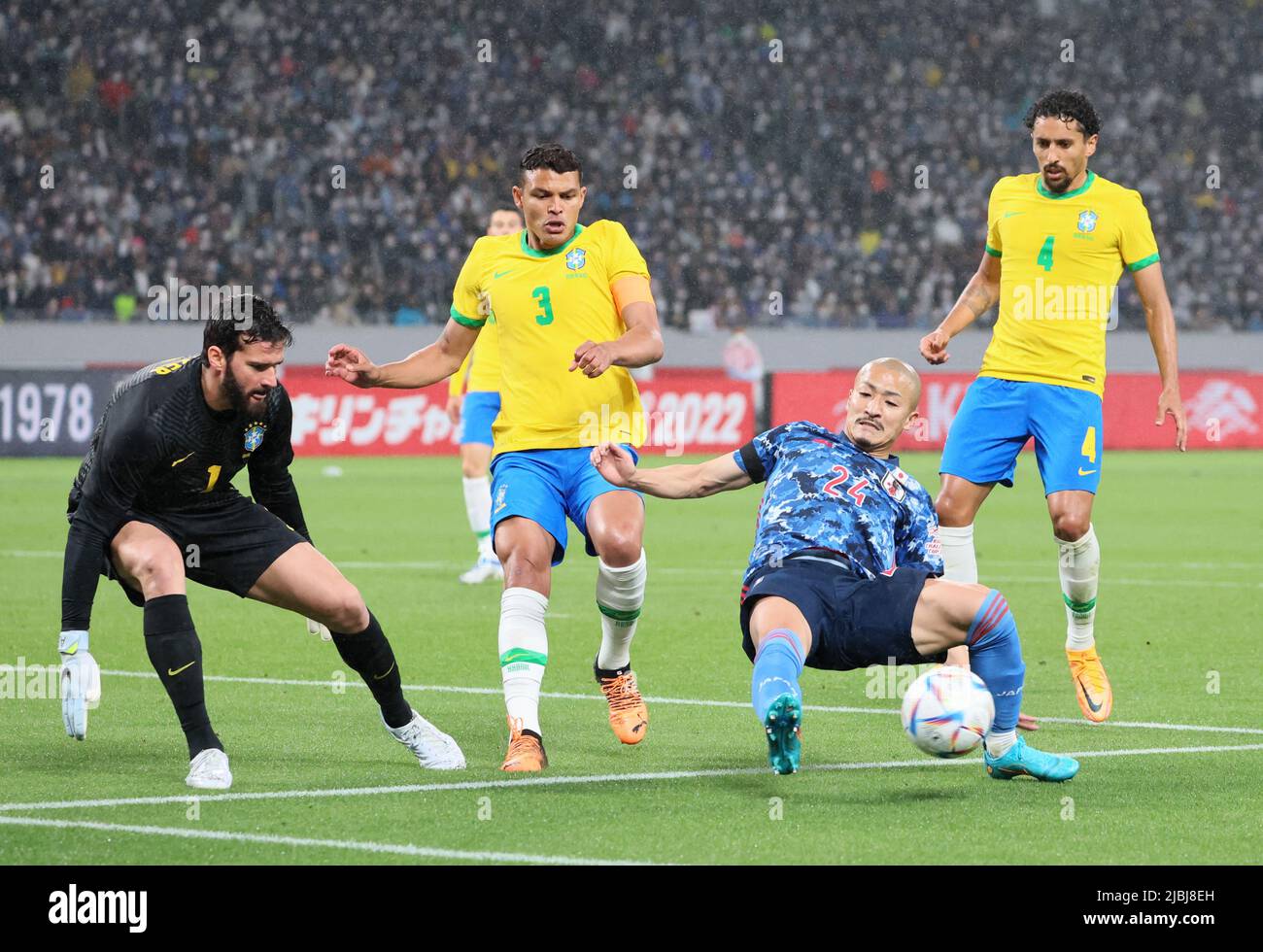 Tokyo, Japan. 6th June, 2022. Japan's Daizen Maeda (2nd R) fights the ball against Brazil's goalie Alisson (L), Thiago Silva (2nd L) and Marquinhos (R) during a friendly match 'Kirin Challenge Cup' between Brazil and Japan at the national stadium in Tokyo on Monday, June 6, 2022. Brazil defeated Japan 1-0 with a goal of Neymar's penalty kick. Credit: Yoshio Tsunoda/AFLO/Alamy Live News Stock Photo