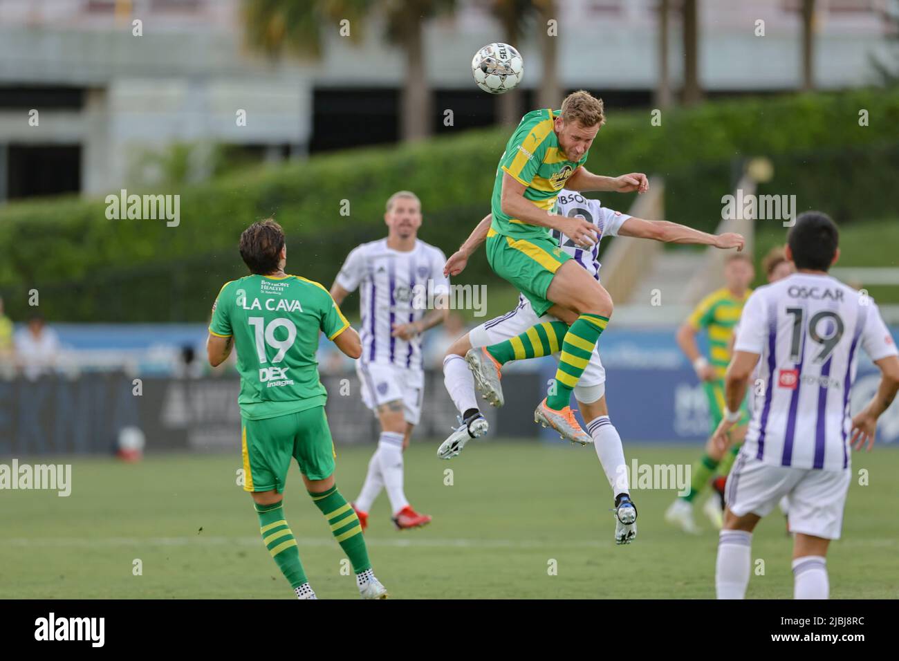 St. Petersburg, FL: Tampa Bay Rowdies forward Kyle Greig (22) and Louisville City FC midfielder Tyler Gibson (12) go up for a header during a USL socc Stock Photo