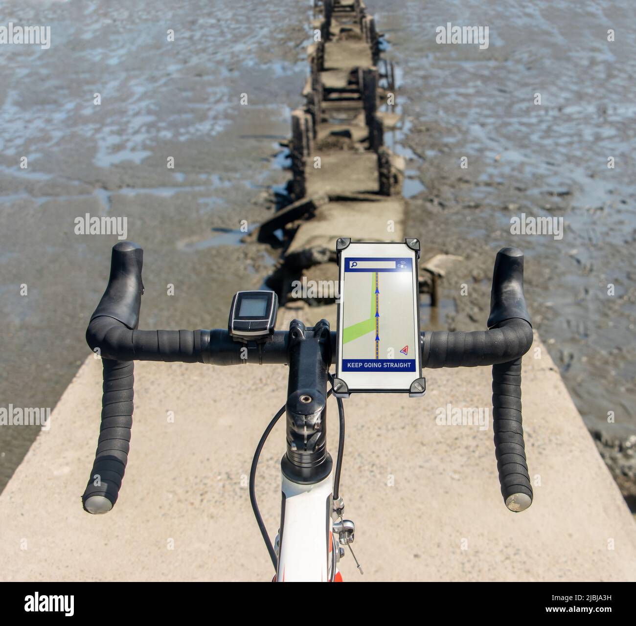 The handlebars of bicycle with incorrect navigation standing on the edge of a demolished way Stock Photo