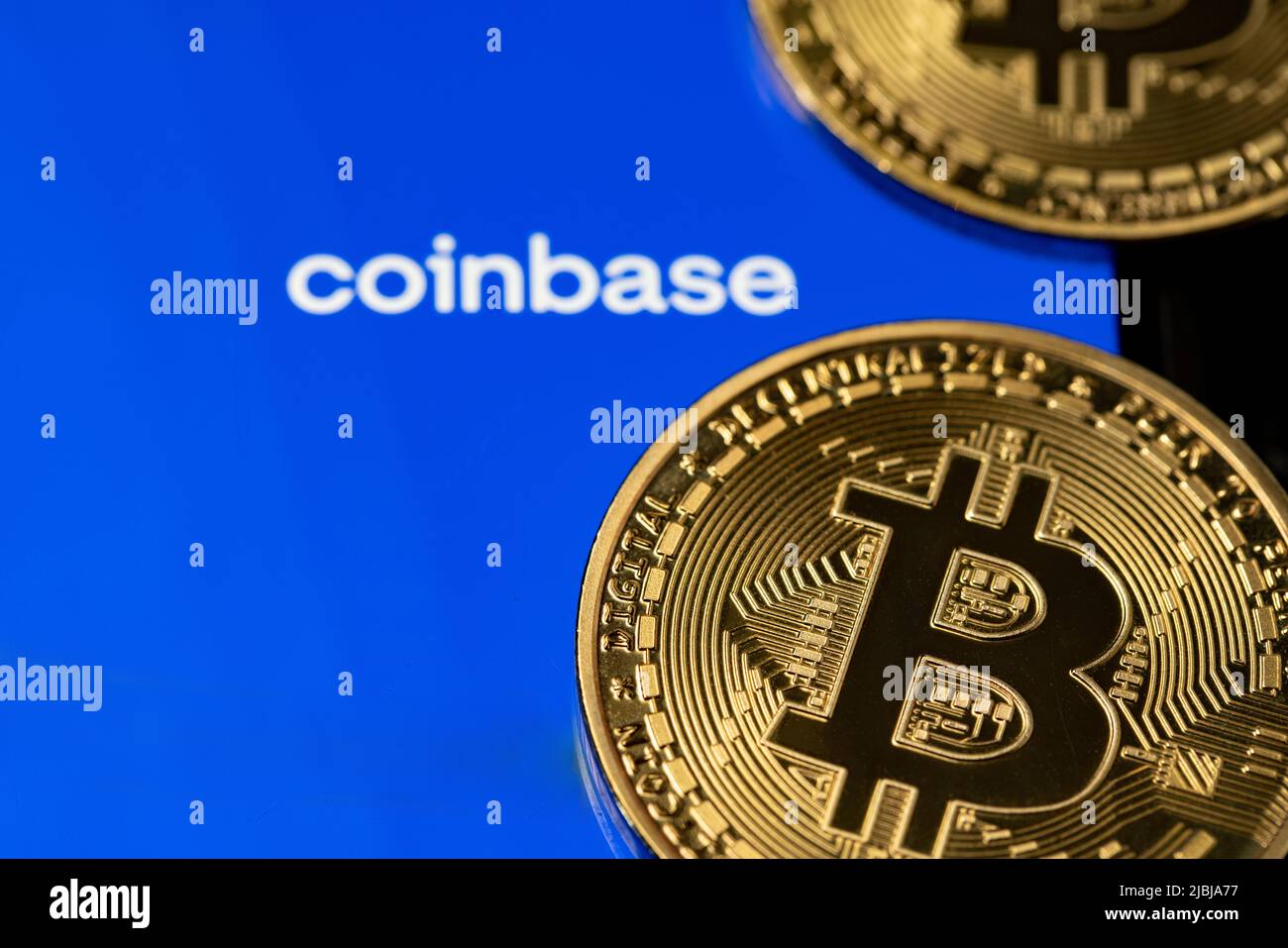 Bolzano, Italy - April 10. 2021: Coinbase app with gold bitcoin coins on smartphone Stock Photo