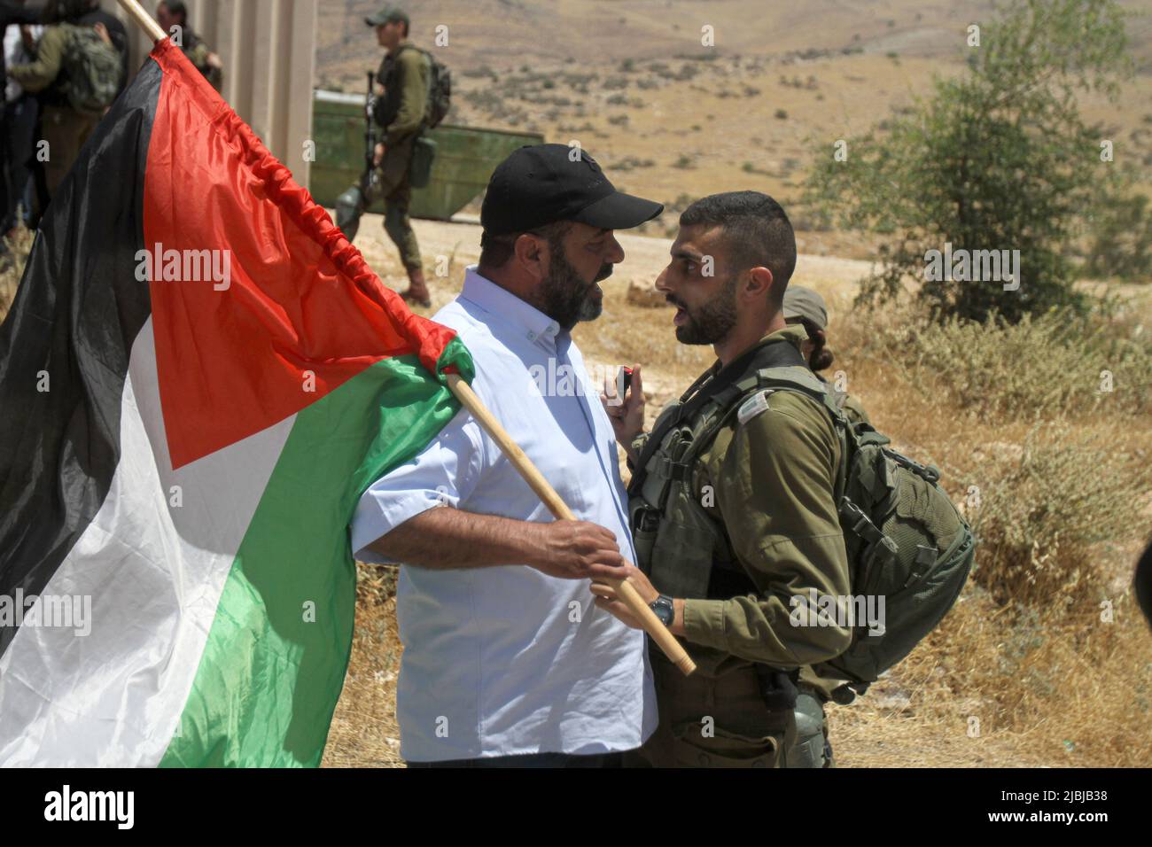 Jordan Valley, Palestine. 06th June, 2022. An Israeli soldier suppresses a Palestinian Protester holding a Palestinian flag during the demonstration against land confiscation in the northern Jordan Valley in the occupied West Bank. Credit: SOPA Images Limited/Alamy Live News Stock Photo