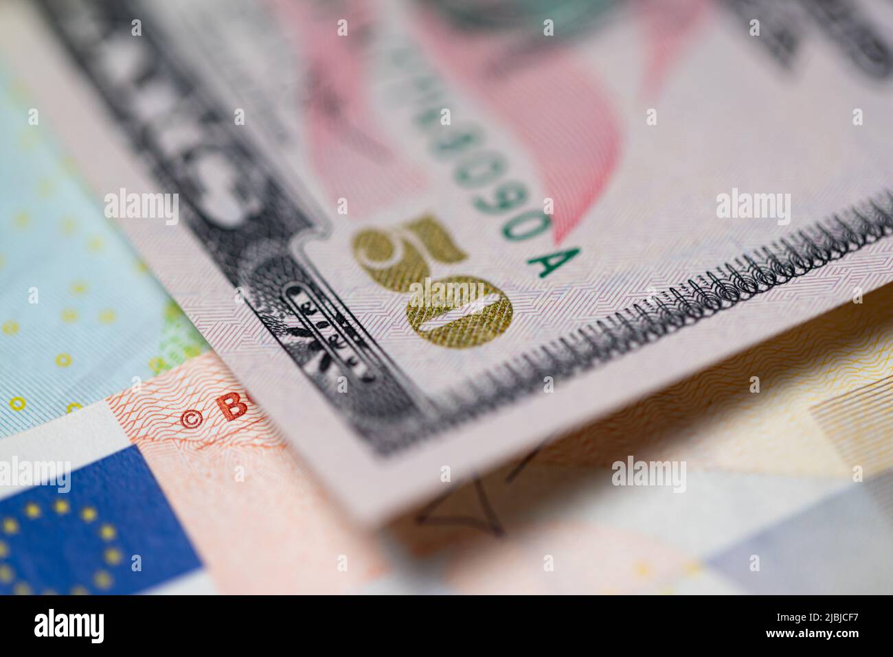 Fifty dollar bills next to euro bill. Currency exchange concept from euro to US dollar money. Stock Photo
