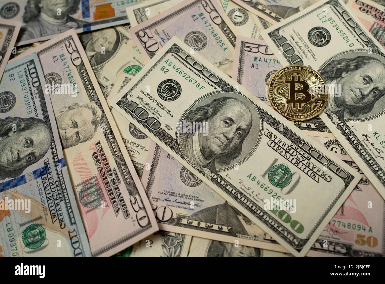 Bitcoin on 100 dollar bill background for design purpose Stock Photo - Alamy