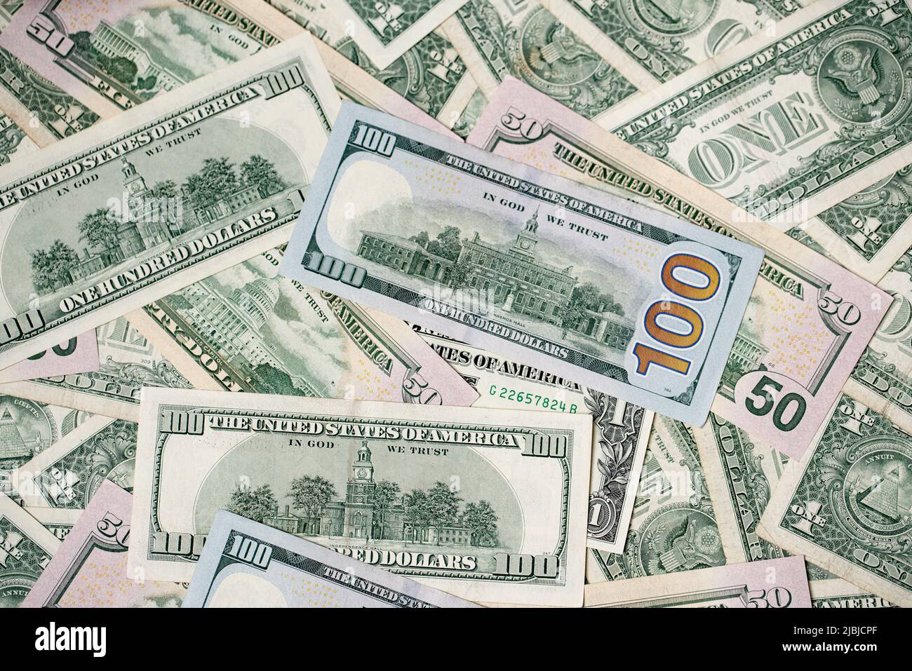 US dollar banknotes as background. One hundred dollar bills spread out. Fifty and 100 USD paper bills Stock Photo