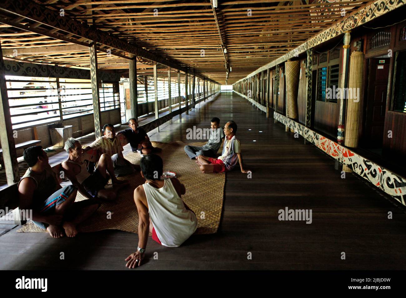 Men taking part in a meeting, a part of the preparation for an ecotourism event at Bali Gundi longhouse of traditional Dayak Taman community in Sibau Hulu, Putussibau Utara, Kapuas Hulu, West Kalimantan, Indonesia. Stock Photo