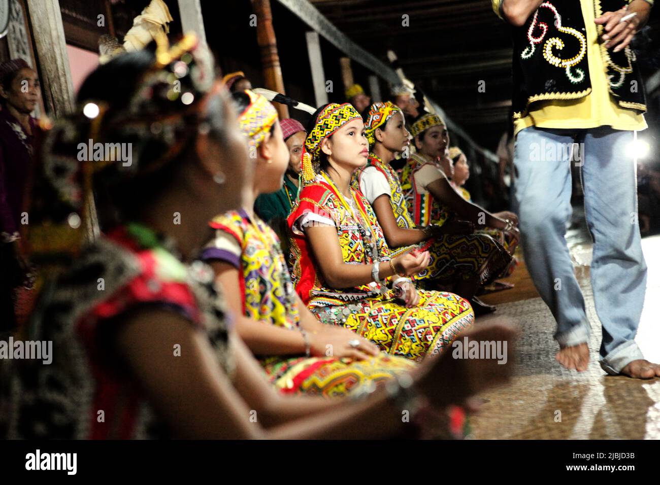 Young women in traditional attire sitting for a welcome ceremony during an ecotourism event at Bali Gundi longhouse of traditional Dayak Taman community in Sibau Hulu, Putussibau Utara, Kapuas Hulu, West Kalimantan, Indonesia. Stock Photo