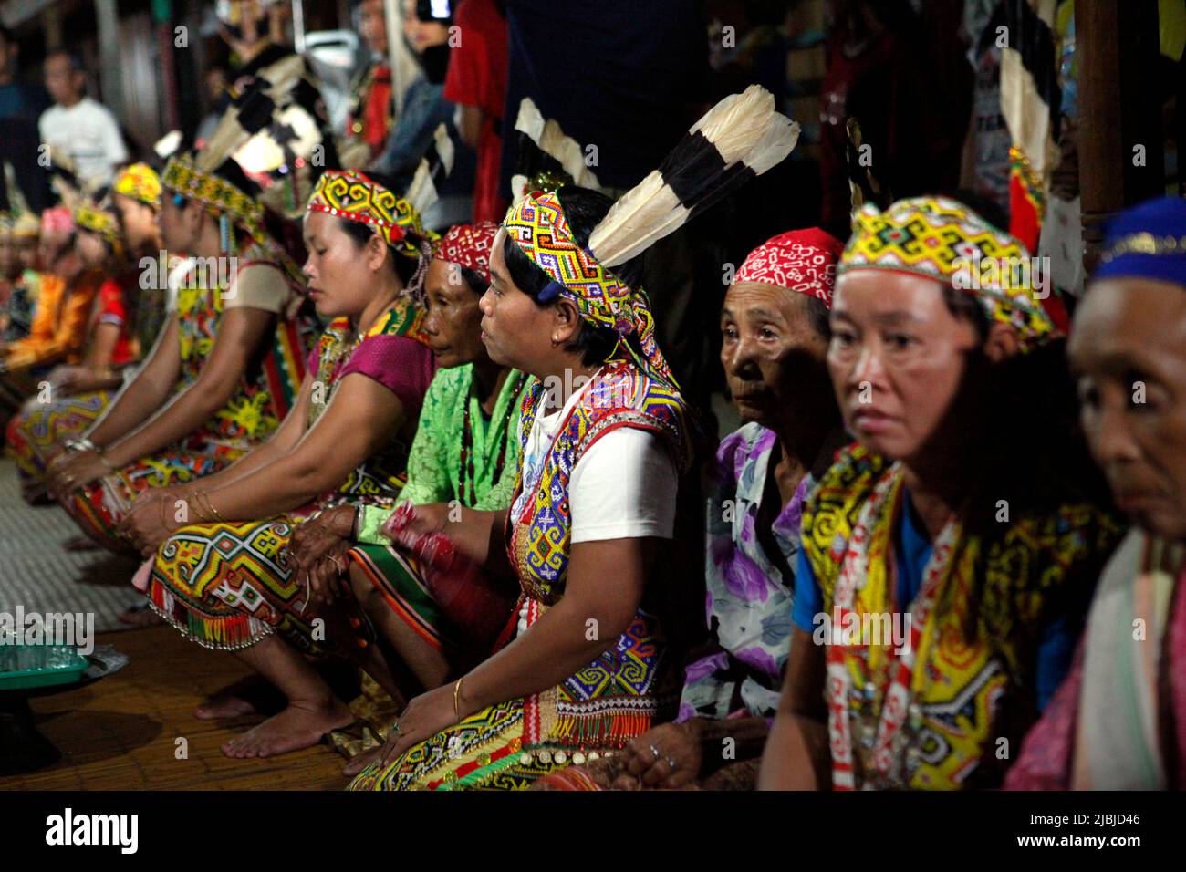 Women in traditional attire sitting for a welcome ceremony during an ecotourism event at Bali Gundi longhouse of traditional Dayak Taman community in Sibau Hulu, Putussibau Utara, Kapuas Hulu, West Kalimantan, Indonesia. Stock Photo