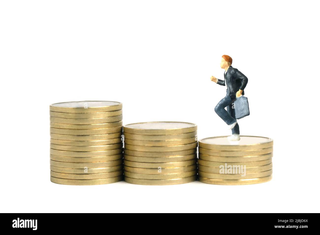 Miniature people toy figure photography. School admission budget concept. Young men pupils running above golden coin cent money staircase, isolated on Stock Photo