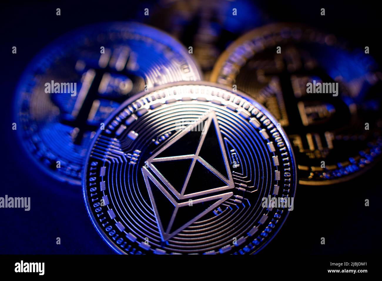 Ethereum Coin and Bitcoin in background. Cryptocurrency ETH and BTC. Tokens Blockchain. High Tech Crypto concept. Decentralized crypto currency Ether Stock Photo