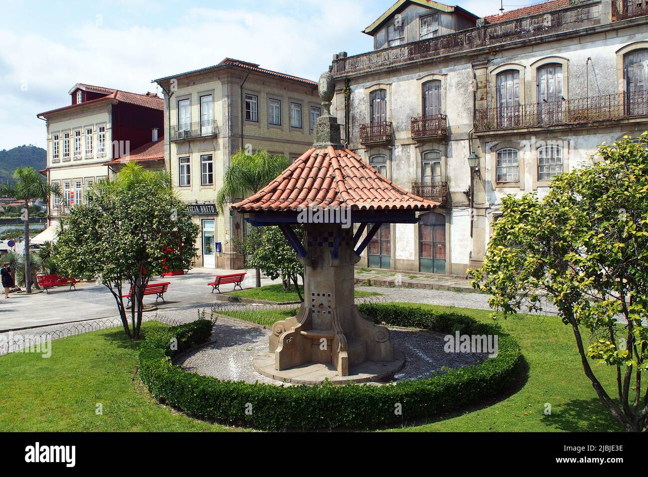 Street scene in the old town, at Largo Antonio de Magalhaes, old tile-roofed drinking fountain, Ponte de Lima, Portugal Stock Photo
