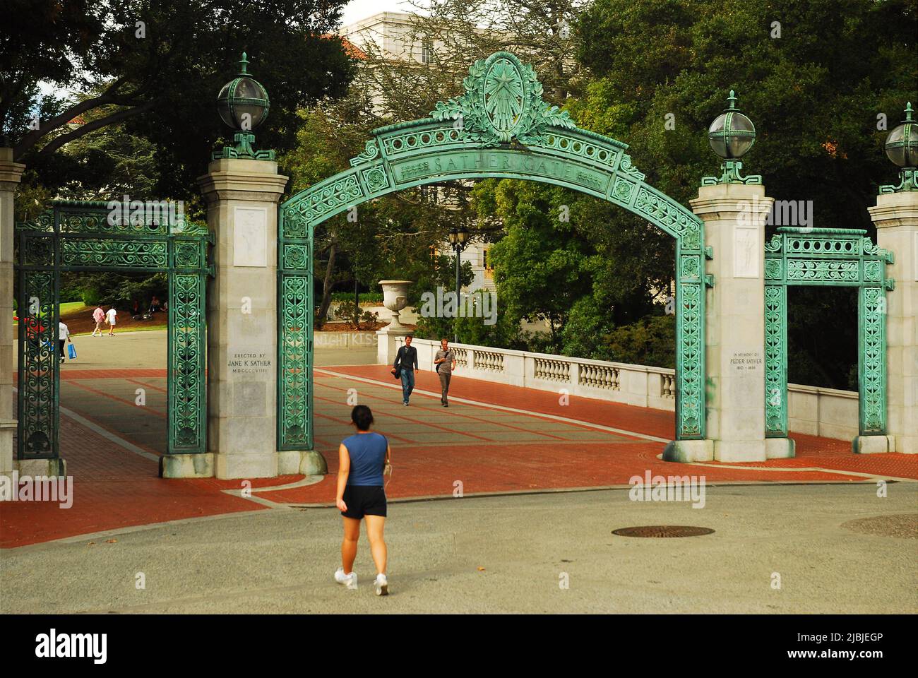 A student walks through the historic Sather gates and the entrance to the campus of the University of California at Berkeley Stock Photo