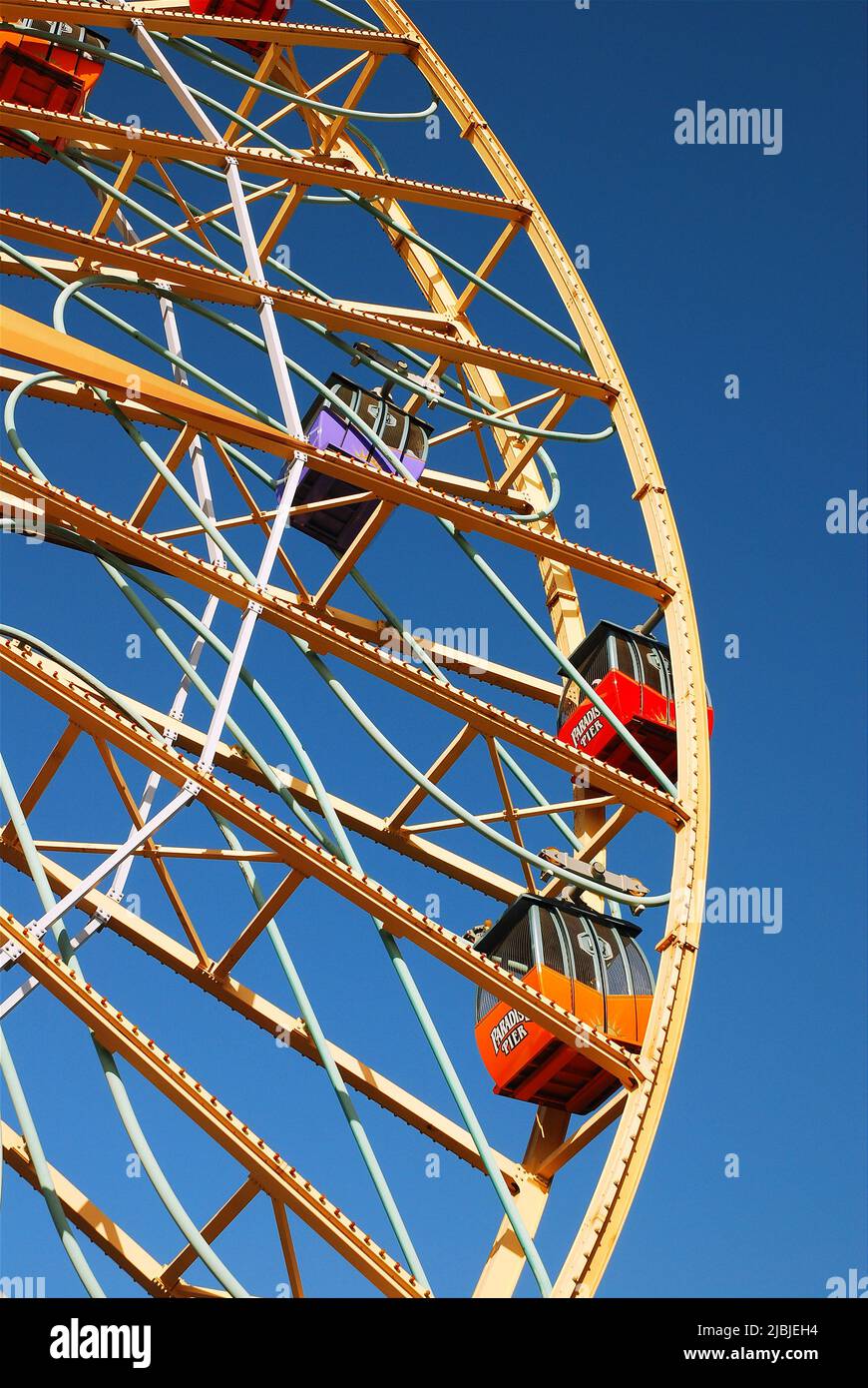 The Ferris Wheel takes riders on a relaxing trip for a nice view at an amusement park Stock Photo