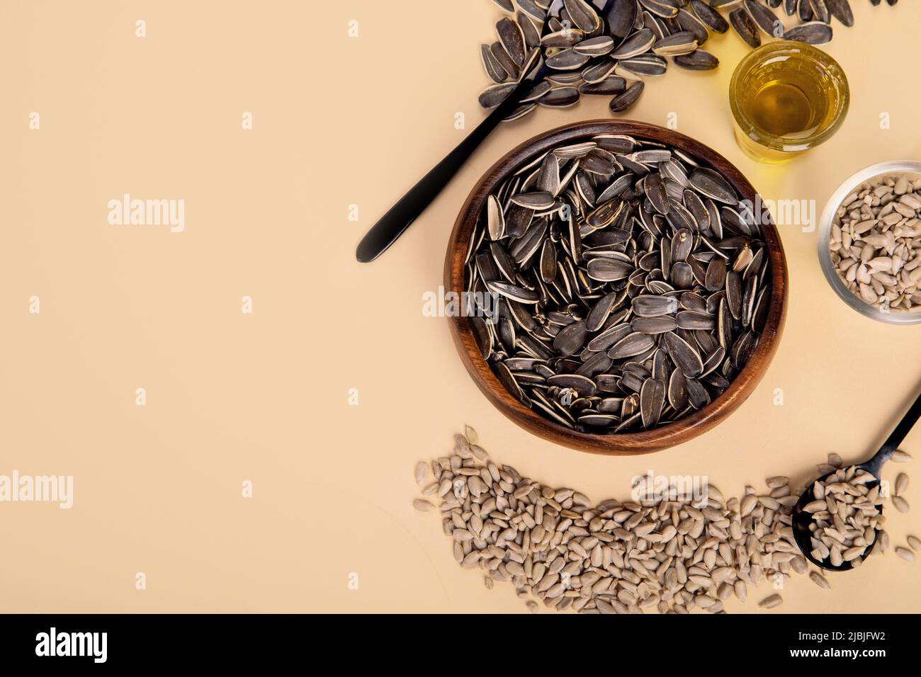 Sunflower oil and sunflower seeds on colourfull background. Organic concept. Healthy food and fats. Top view, copy space, flat lay Stock Photo