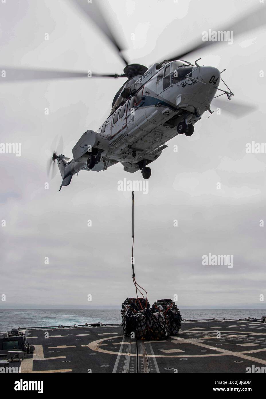 PACIFIC OCEAN (June 3, 2022) An AS 332 Super Puma helicopter assigned to  Lewis and Clark-class dry cargo ship USNS Richard E. Byrd (T-AKE 4) drops  cargo on the flight deck during