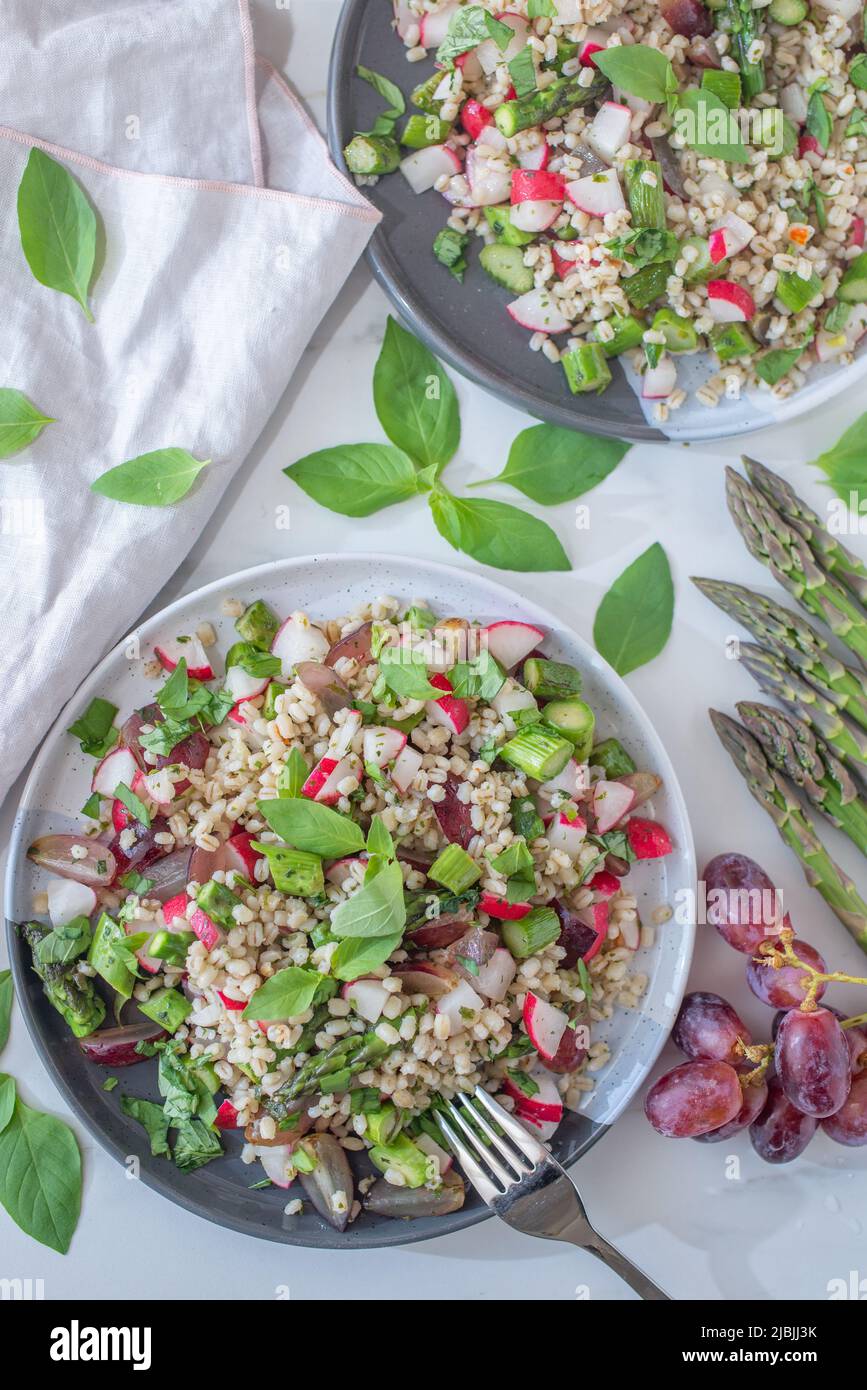 healthy barley spring salad with asparagus and peas Stock Photo