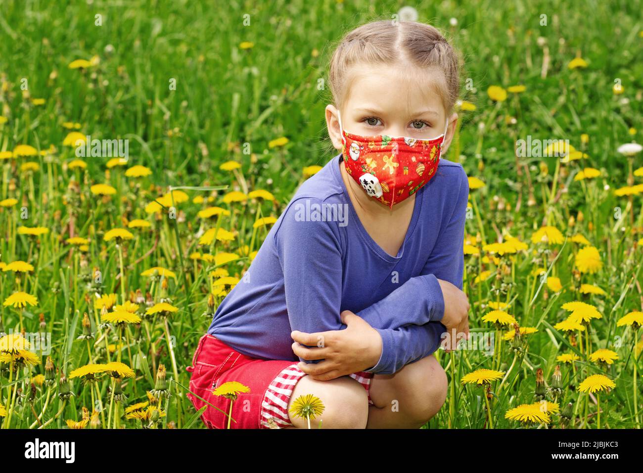 Caucasian little girl wearing mask on face to prevent from pollen