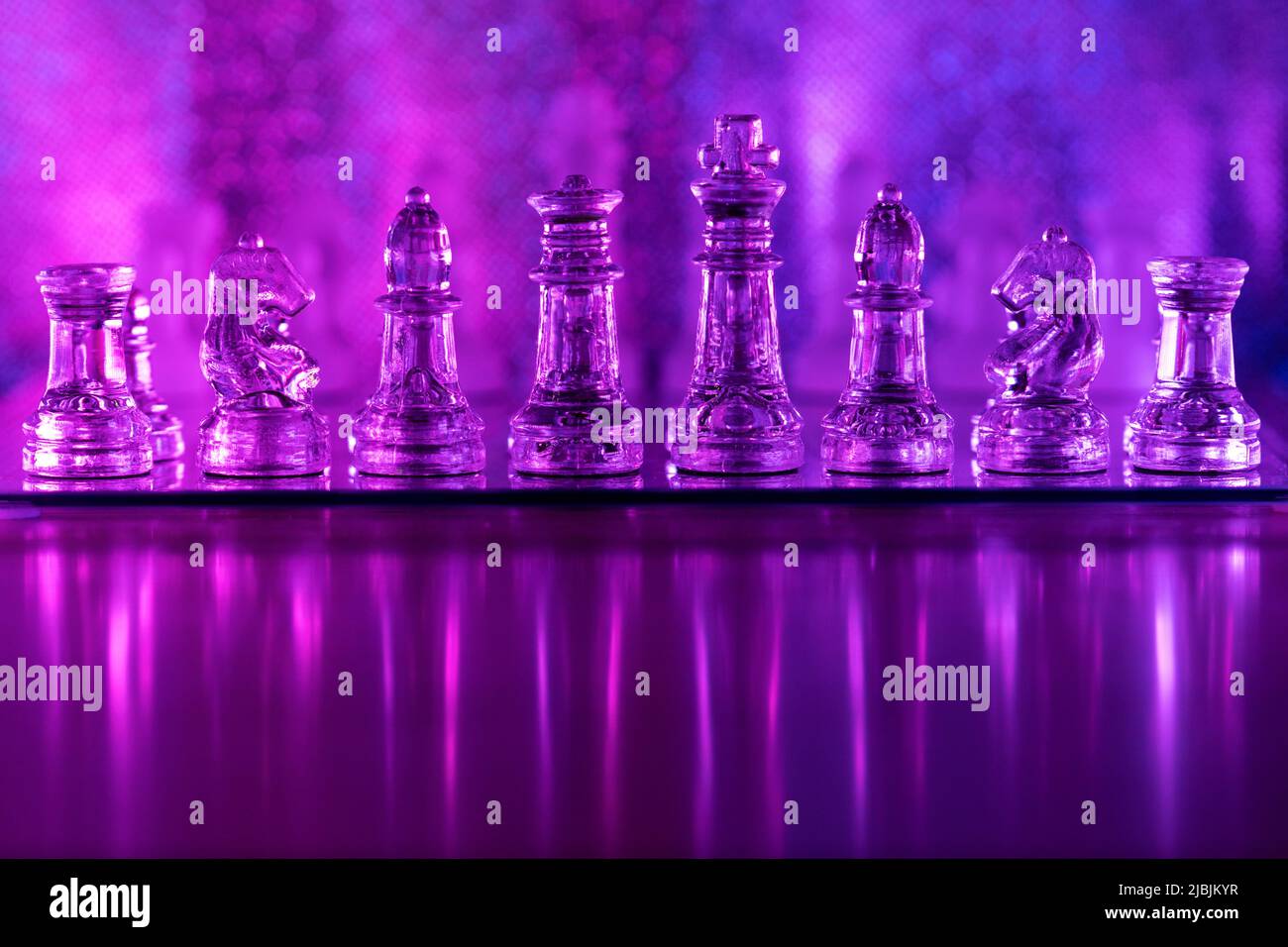 Transparent translucent pieces are placed on chessboard. Concept of