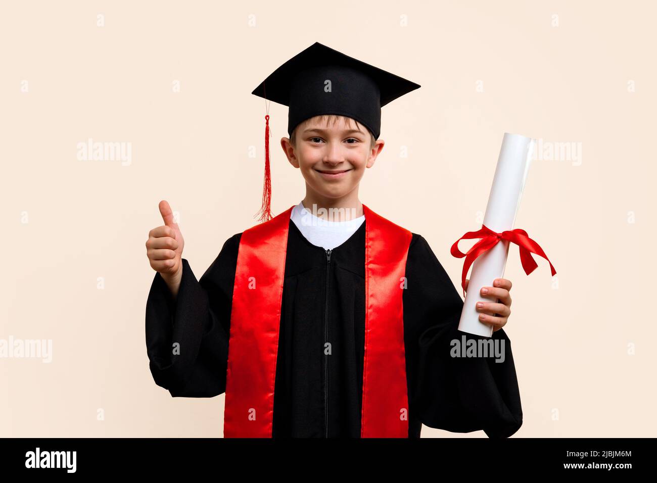 Whizz kid 9 11 year wearing graduation cap and ceremony robe shows