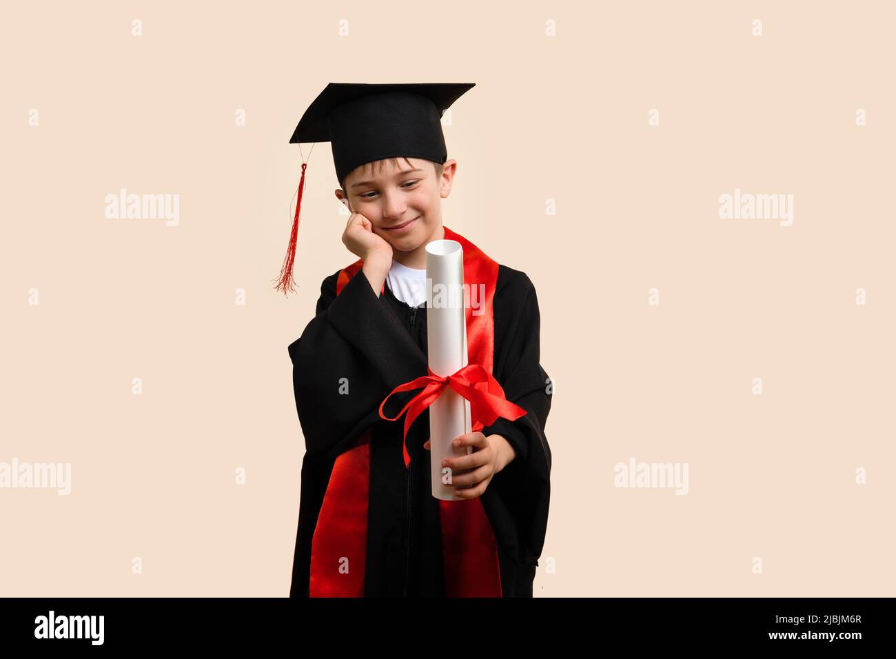 Whizz kid 911 year wearing graduation cap and ceremony robe Looking at