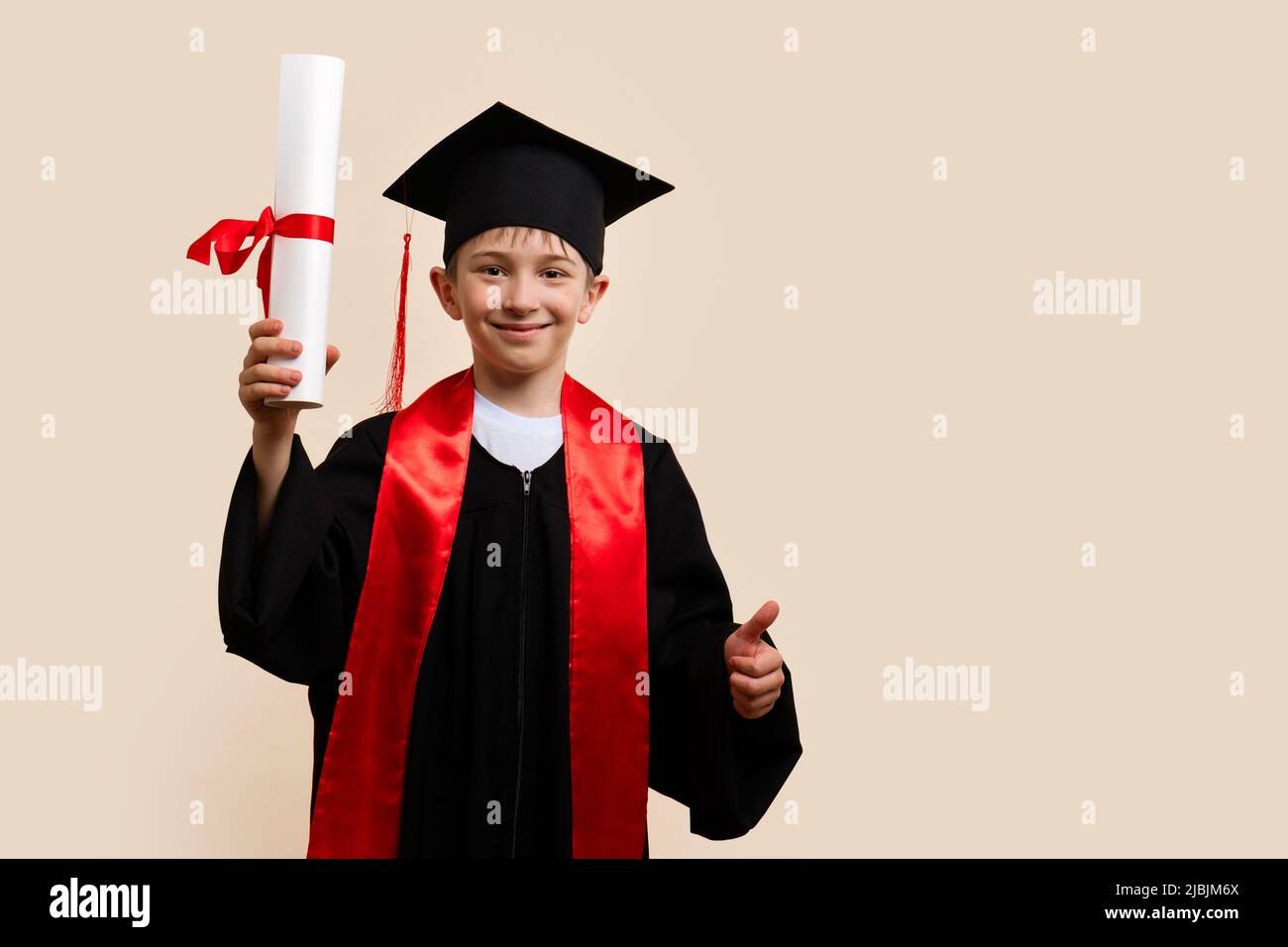 Whizz kid 911 year boy wearing graduation cap and ceremony robe with