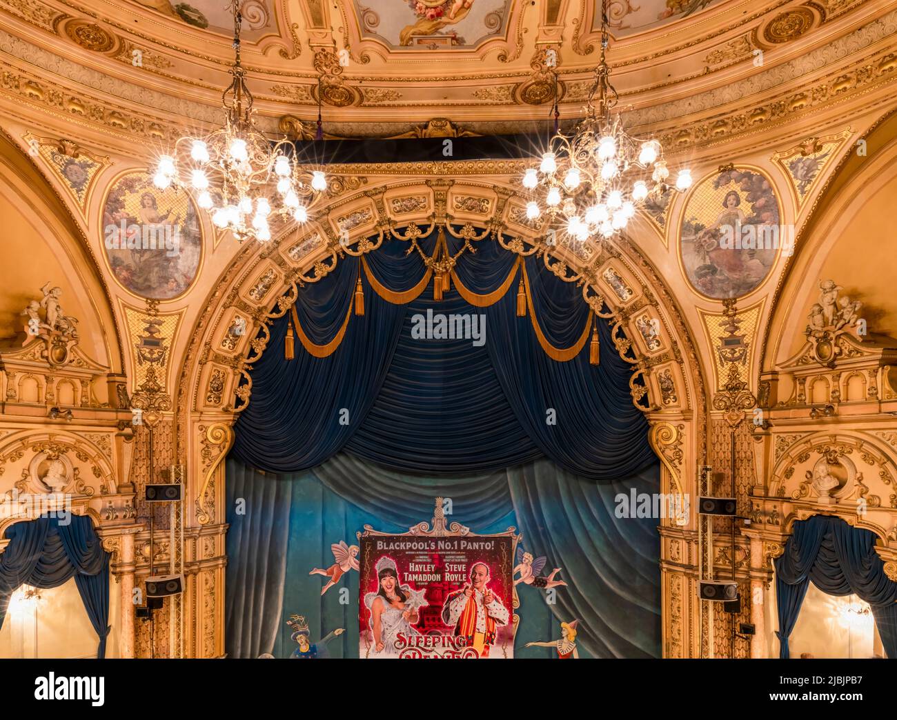 A view of the blue front tabs, stage area and ornate architecture of the Frank Matcham designed, Grand Theatre in Blackpool, Lancashire, UK. Stock Photo