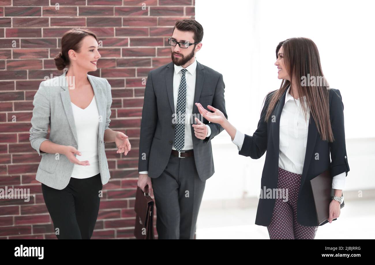 business woman talking to colleagues standing in the office Stock Photo ...