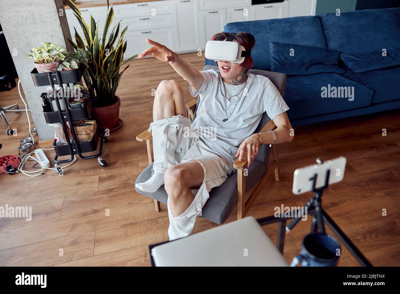 Asian man wearing virtual reality device while pointing by hand Stock Photo