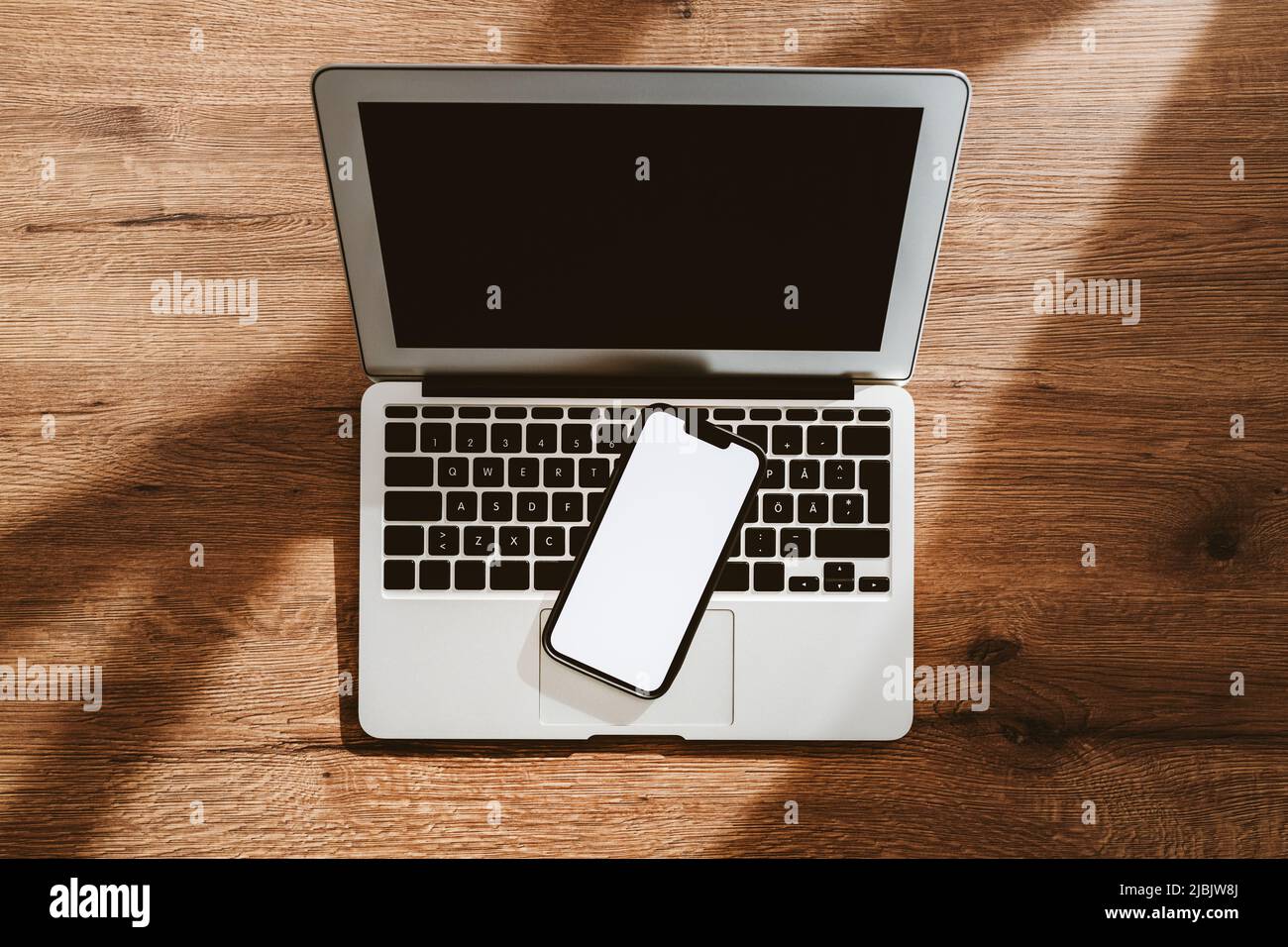 Empty notepad and modern smart phone mockup on white office desk surrounded  with office supplies. Top view. Flat lay Stock Photo - Alamy