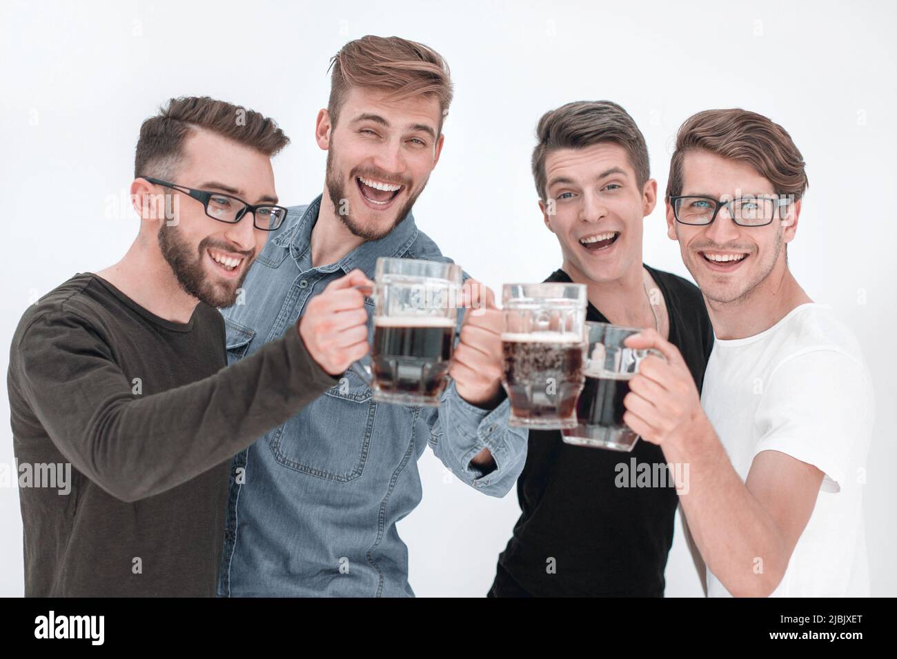 four happy young men, clinking glasses of bee Stock Photo - Alamy