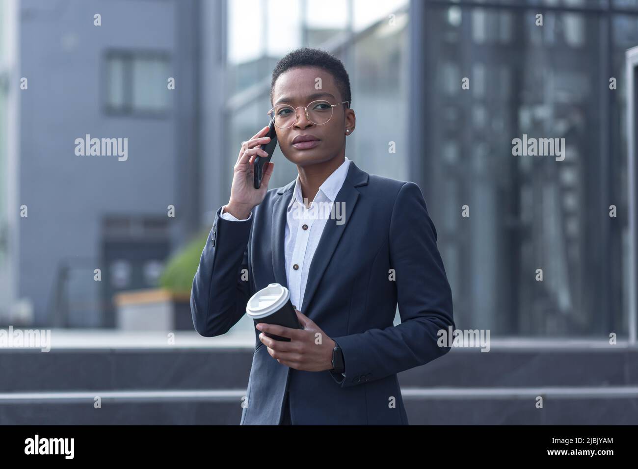 Beautiful businesswomen in a city. Businesswomen in a elegant dress. Ladies  in a city. Pretty girls with phone. Two partners in a fashoin clothes Stock  Photo - Alamy