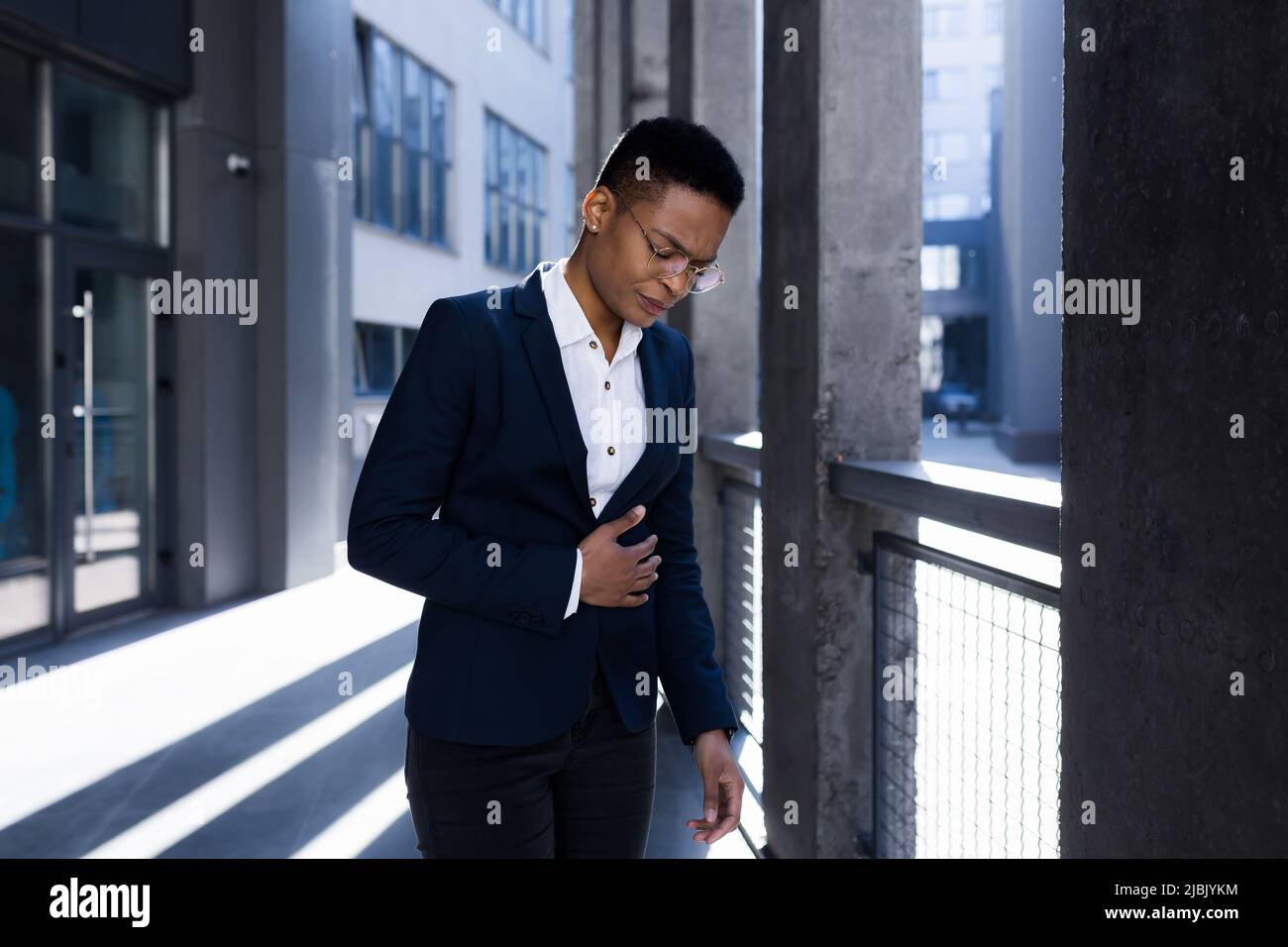 Business woman with severe abdominal pain, outdoors, dizziness, severe