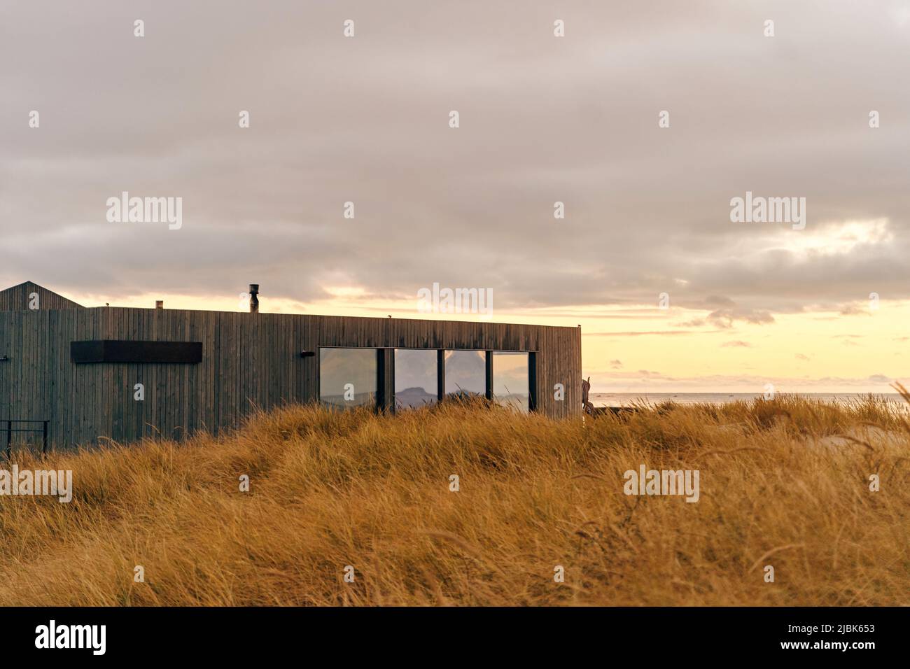 facade of a designer building made of wood on the seashore. Stock Photo