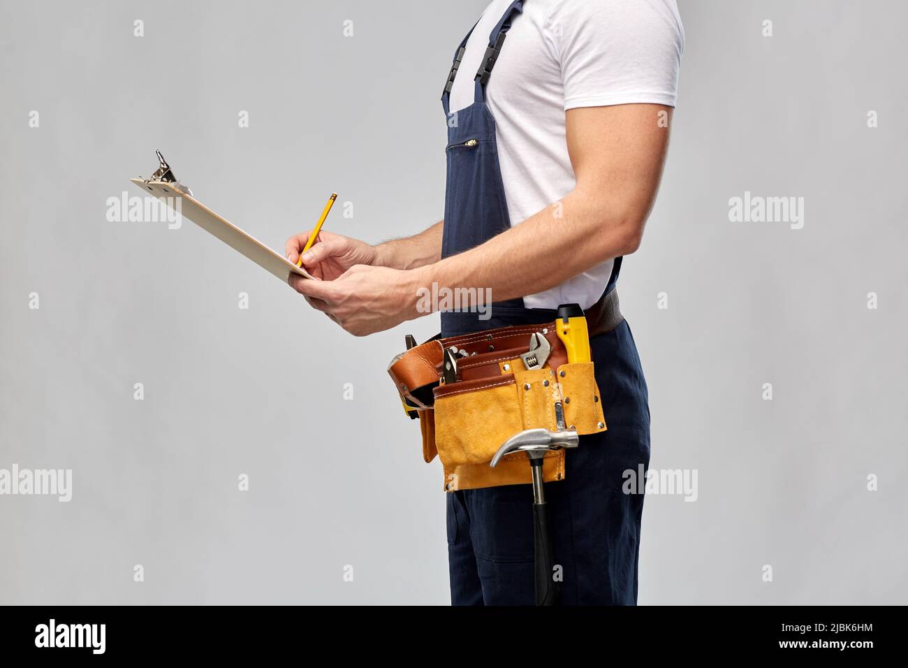 builder with clipboard, pencil and working tools Stock Photo