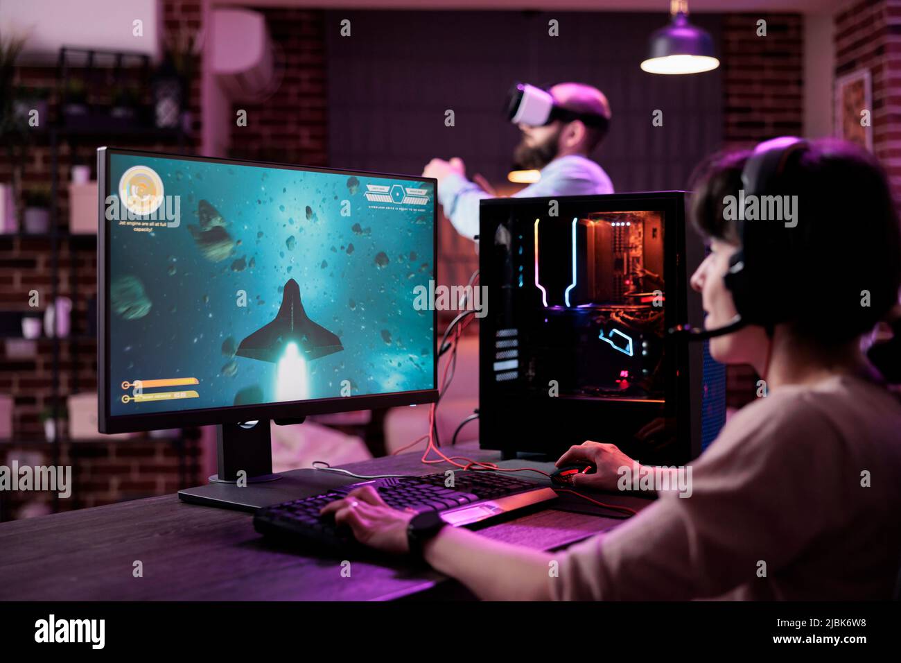Young adult playing shooter video games championship on pc, in living room  with neon lights. Female gamer enjoying action gameplay competition to do  live stream online, having fun on internet Stock Photo -