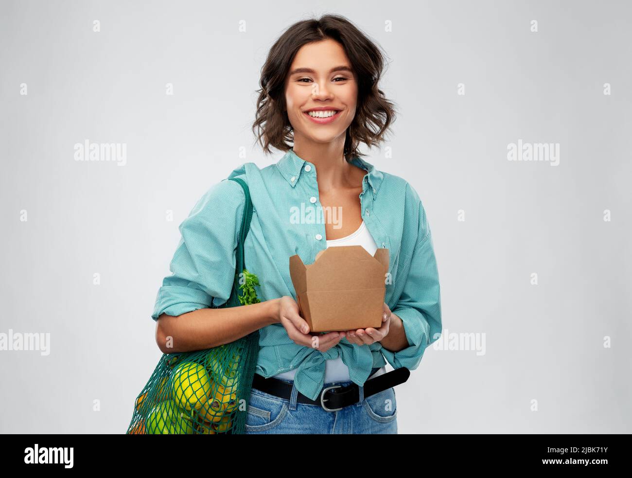 happy woman with food in reusable net bag and wok Stock Photo