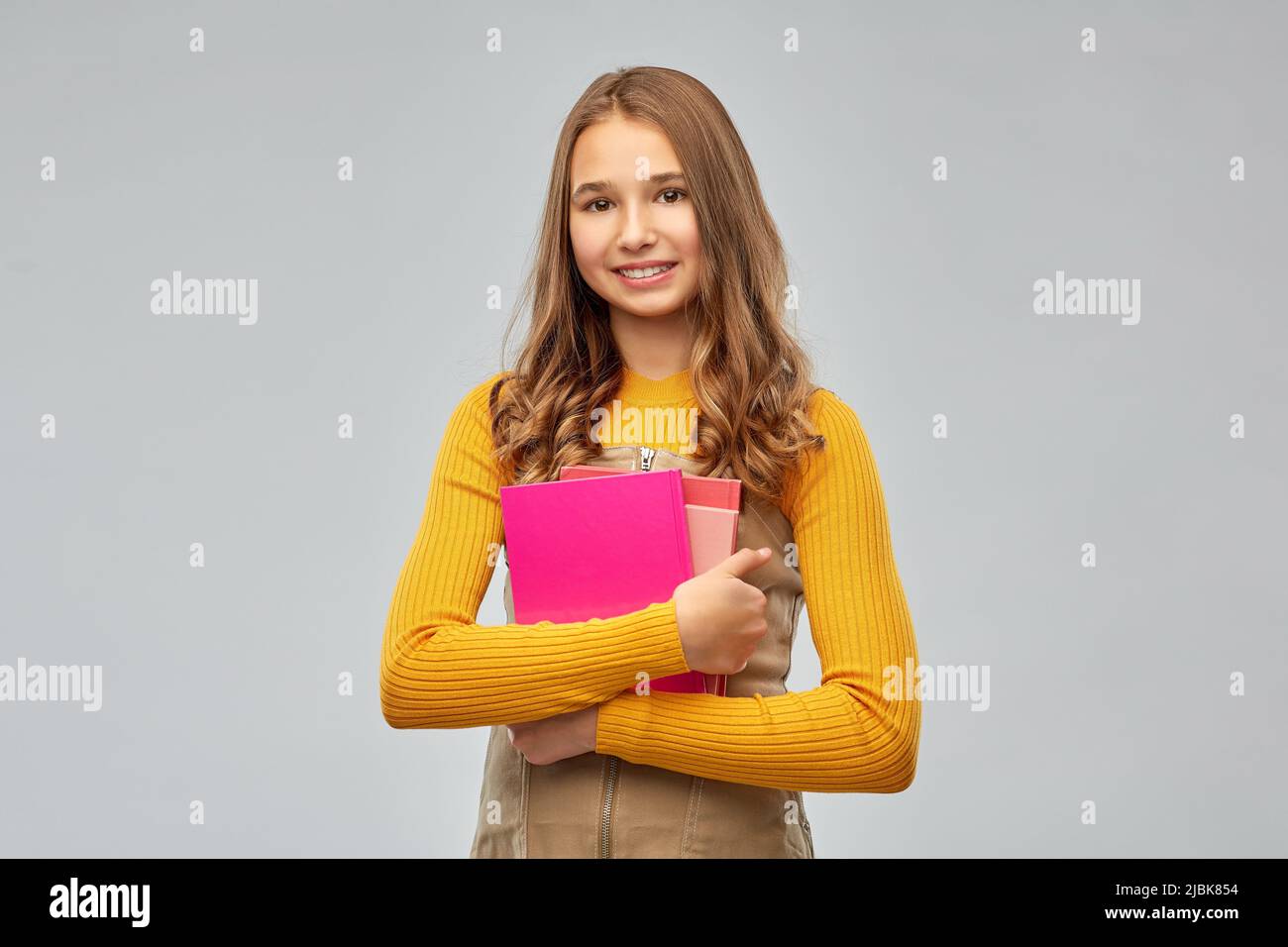 smiling teenage student girl with books Stock Photo - Alamy