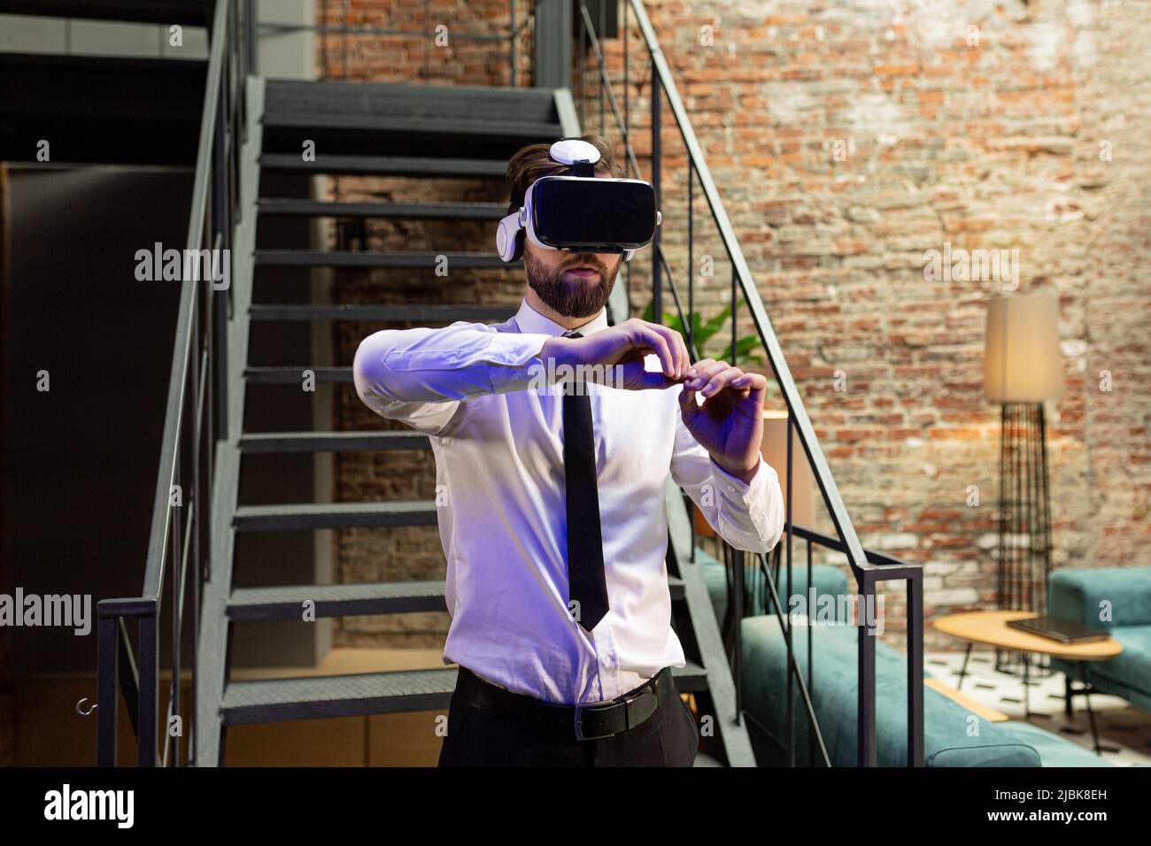 A man office manager in formal clothing wearing virtual reality vr ...