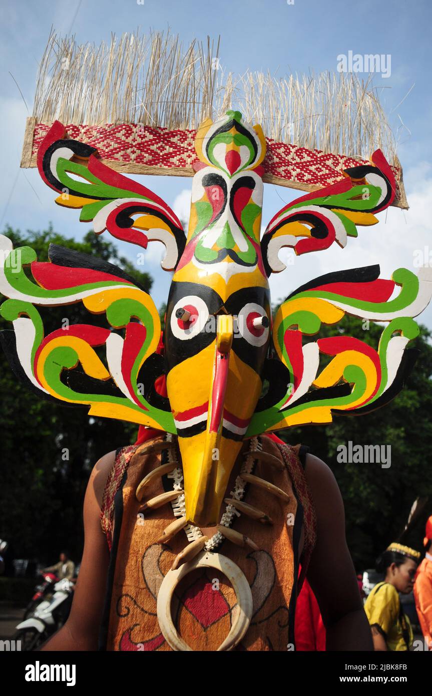 Jakarta, Indonesia - April 28, 2013 : Participants at the Dayak Festival in Jakarta, Indonesia, wear traditional Dayak masks made of wood Stock Photo