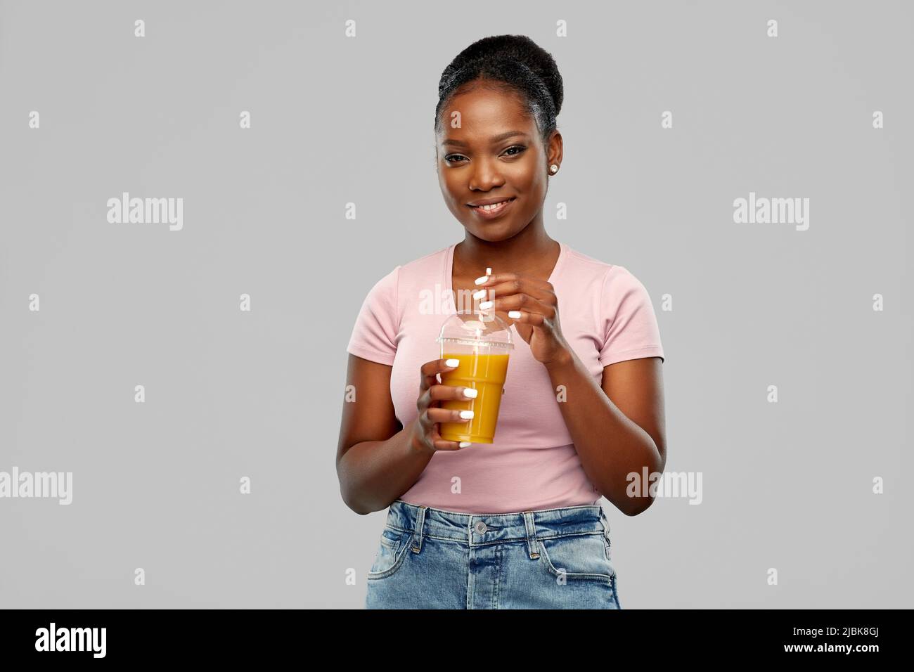 happy african american woman drinking orange juice Stock Photo