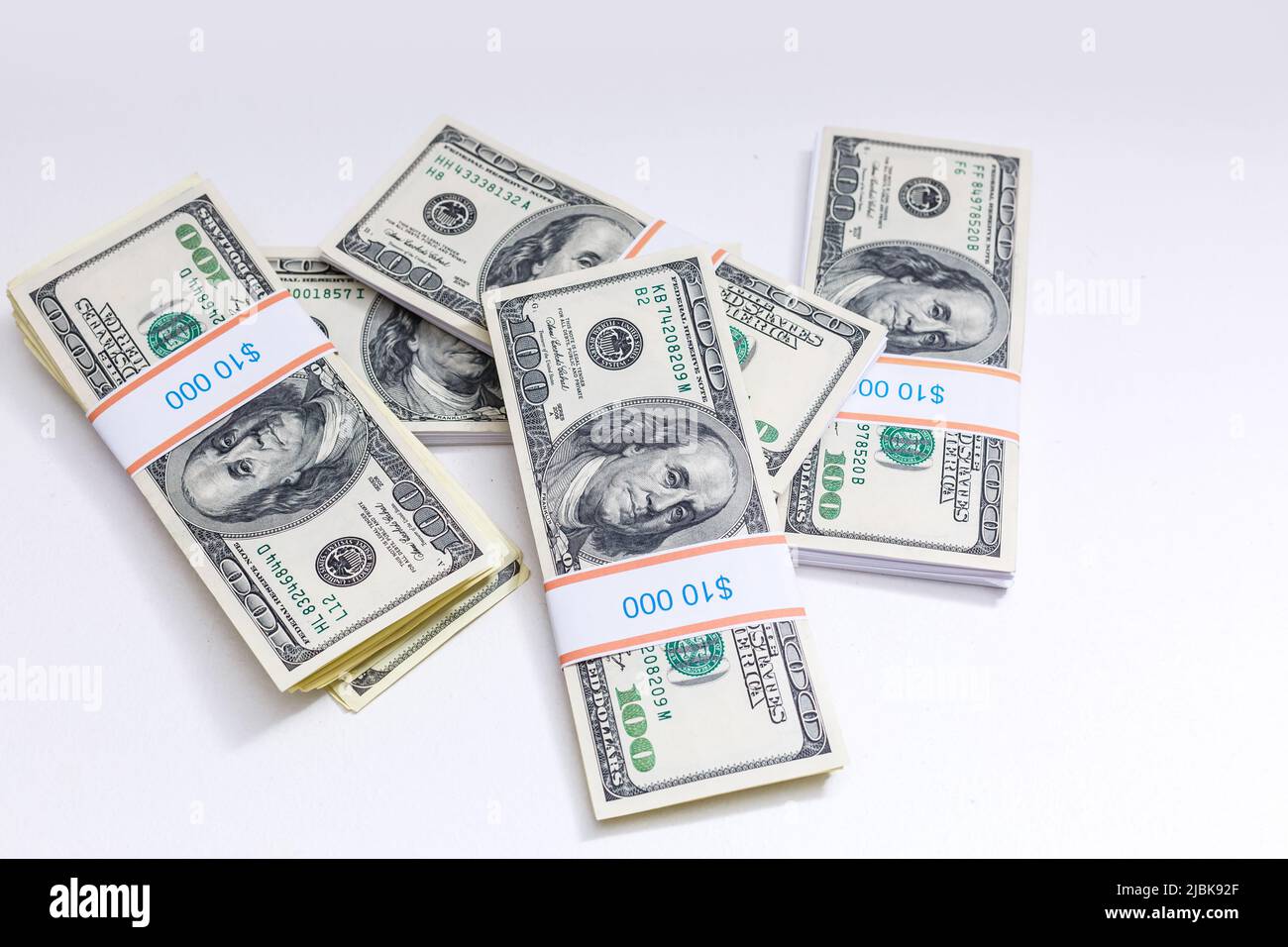 Set of a packs of dollars with a rubber band isolated on a white