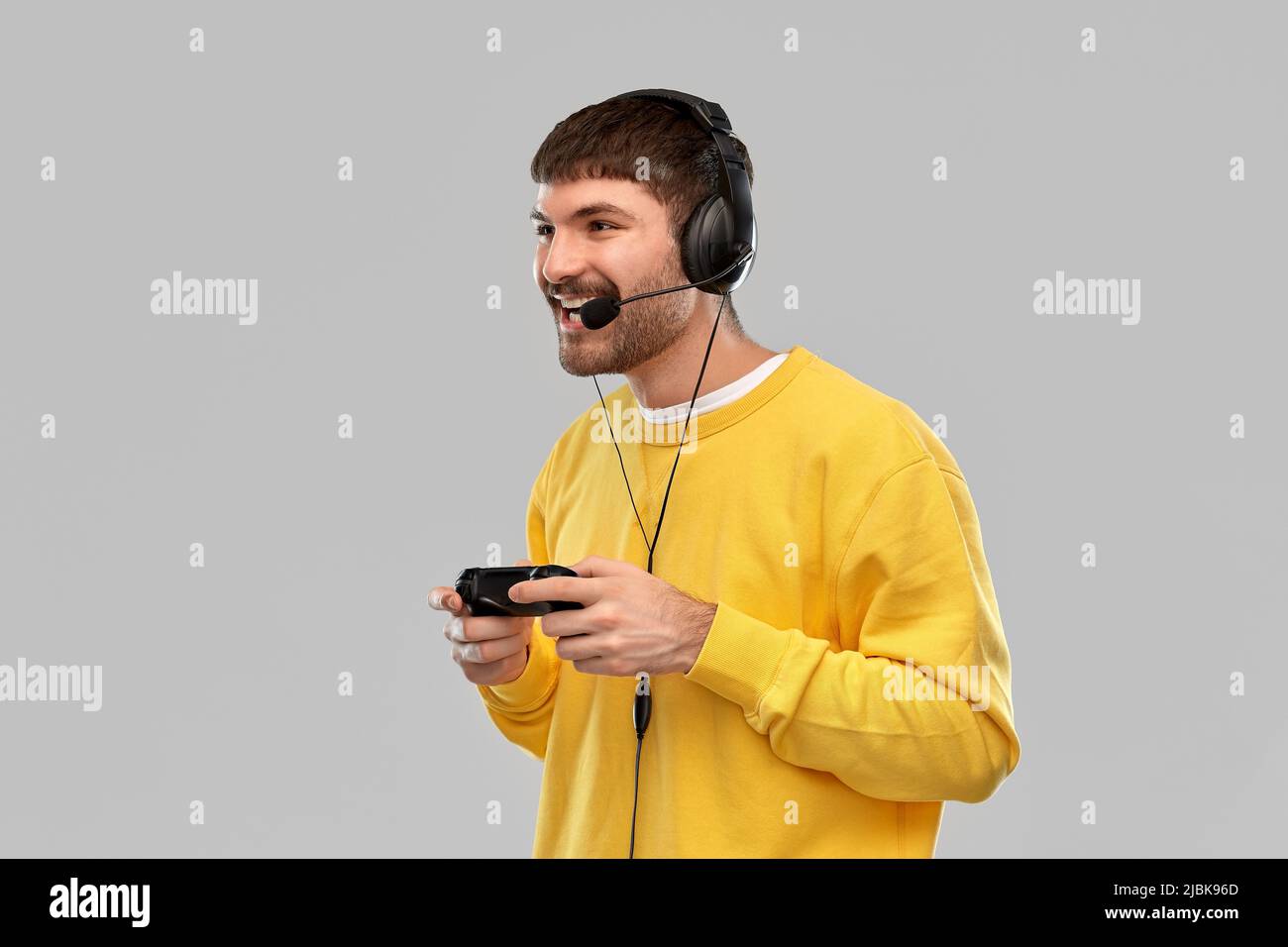 man with headset and gamepad playing video game Stock Photo