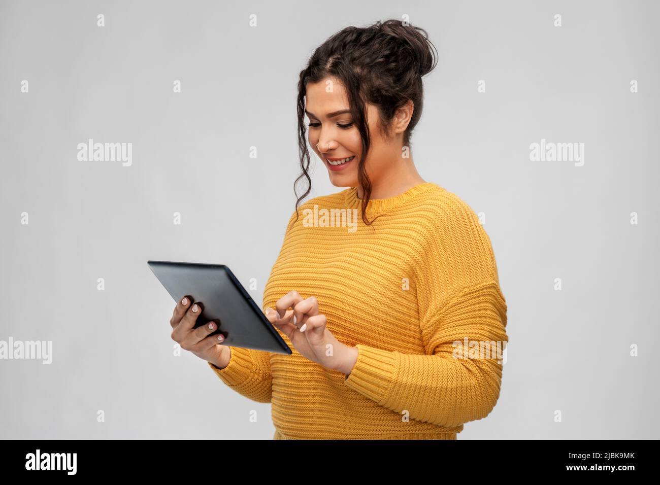 happy young woman using tablet pc computer Stock Photo