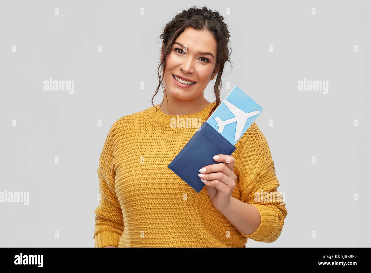 happy young woman with air ticket and passport Stock Photo
