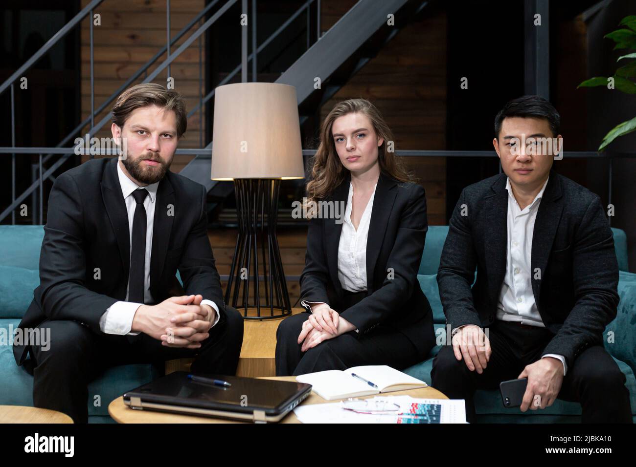 Male businessman in black business suit uses virtual reality goggles, to view economic information, and for online conferences Stock Photo