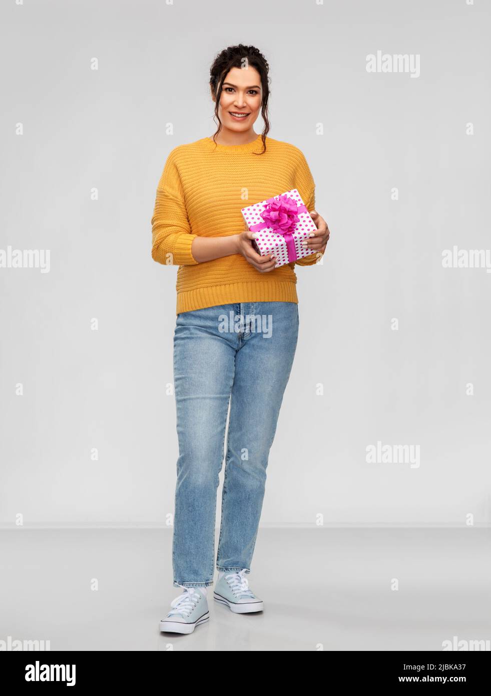 smiling young woman with gift box Stock Photo