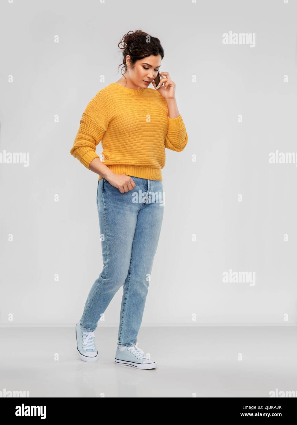 happy young woman calling on smartphone Stock Photo