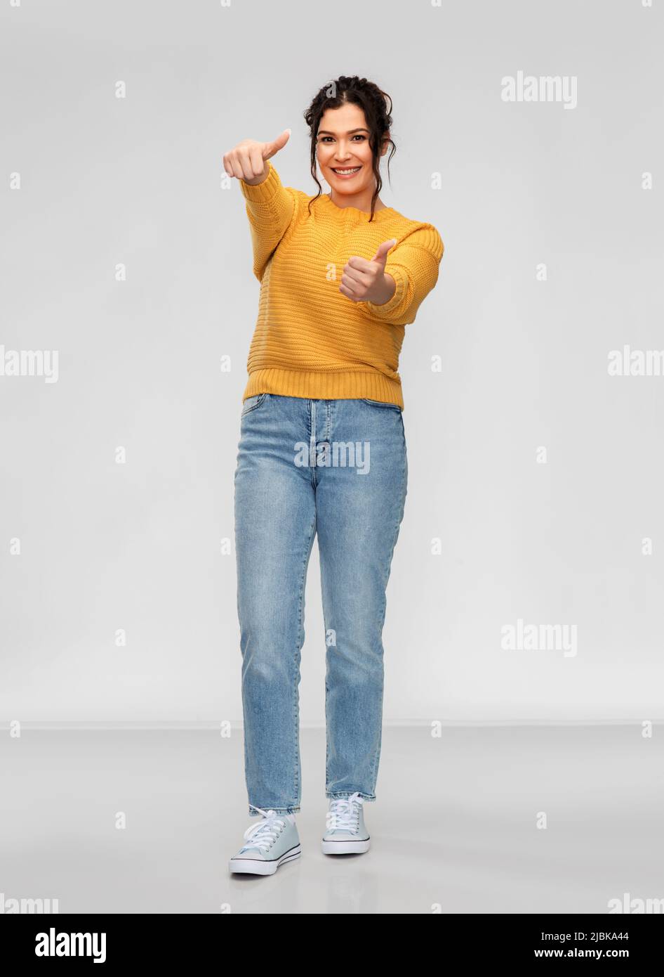happy smiling young woman showing thumbs up Stock Photo