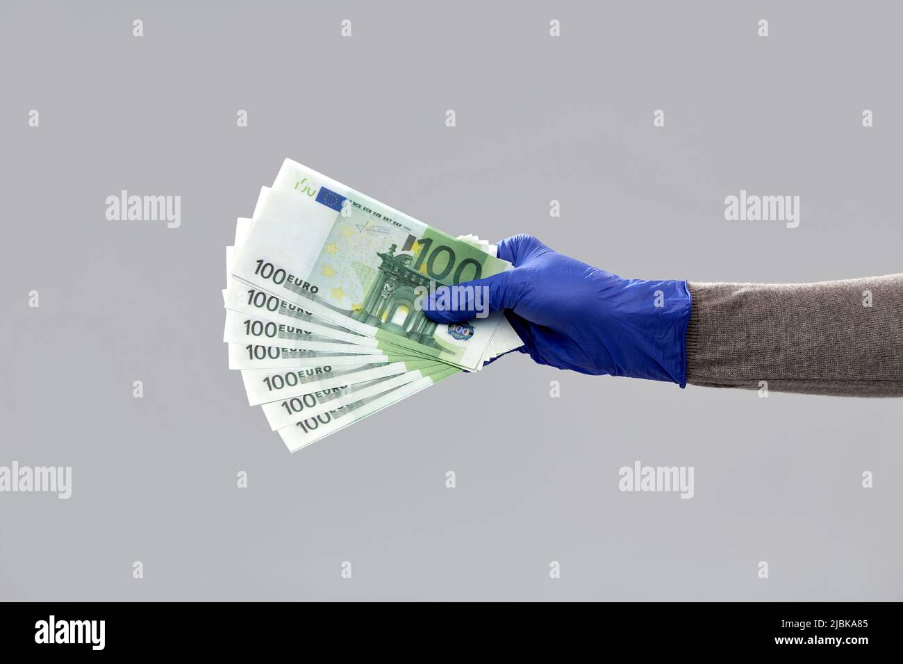 close up of hand in medical glove with money Stock Photo