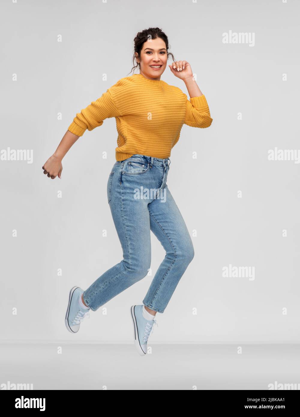 happy young woman with pierced nose jumping Stock Photo