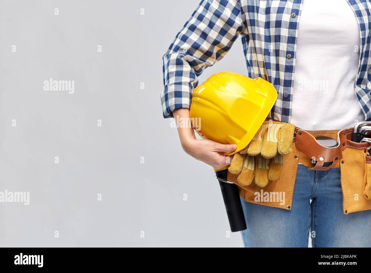woman or builder with helmet and working tools Stock Photo